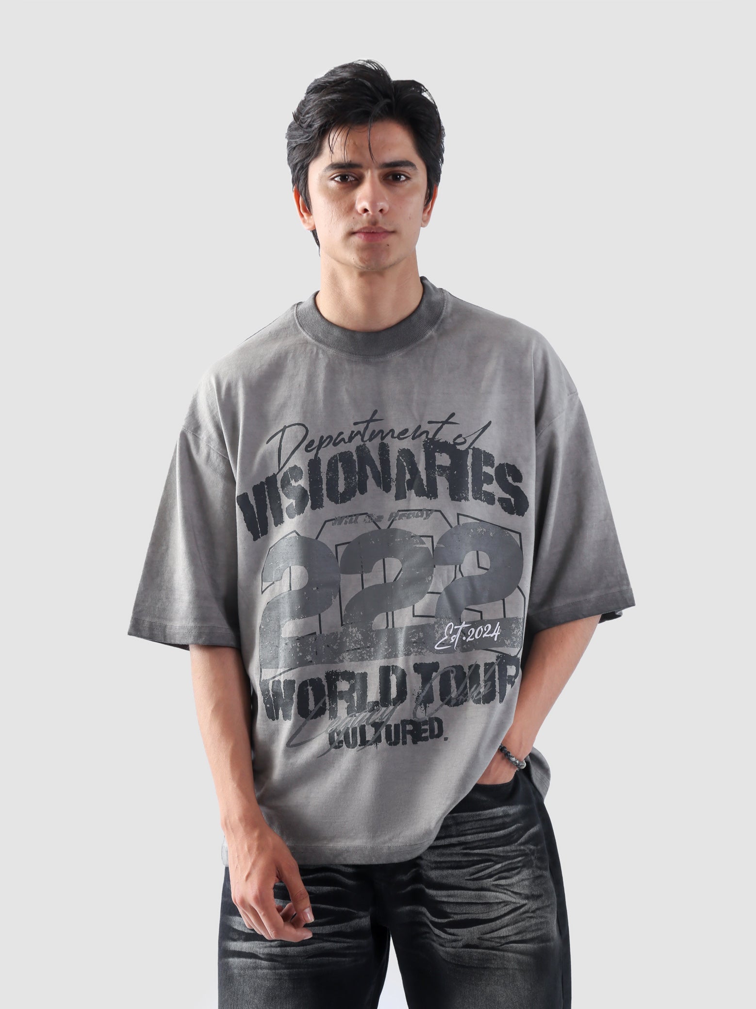 Close-up of Cultured Visionaries graphic design showing “Department of Visionaries 222 World Tour” typography.