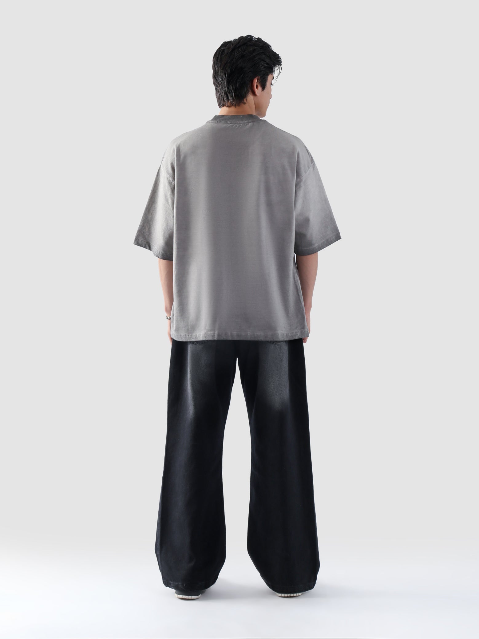 Back side of Cultured’s oil fade oversized t-shirt in plain grey, showcasing loose fit and drop shoulders.