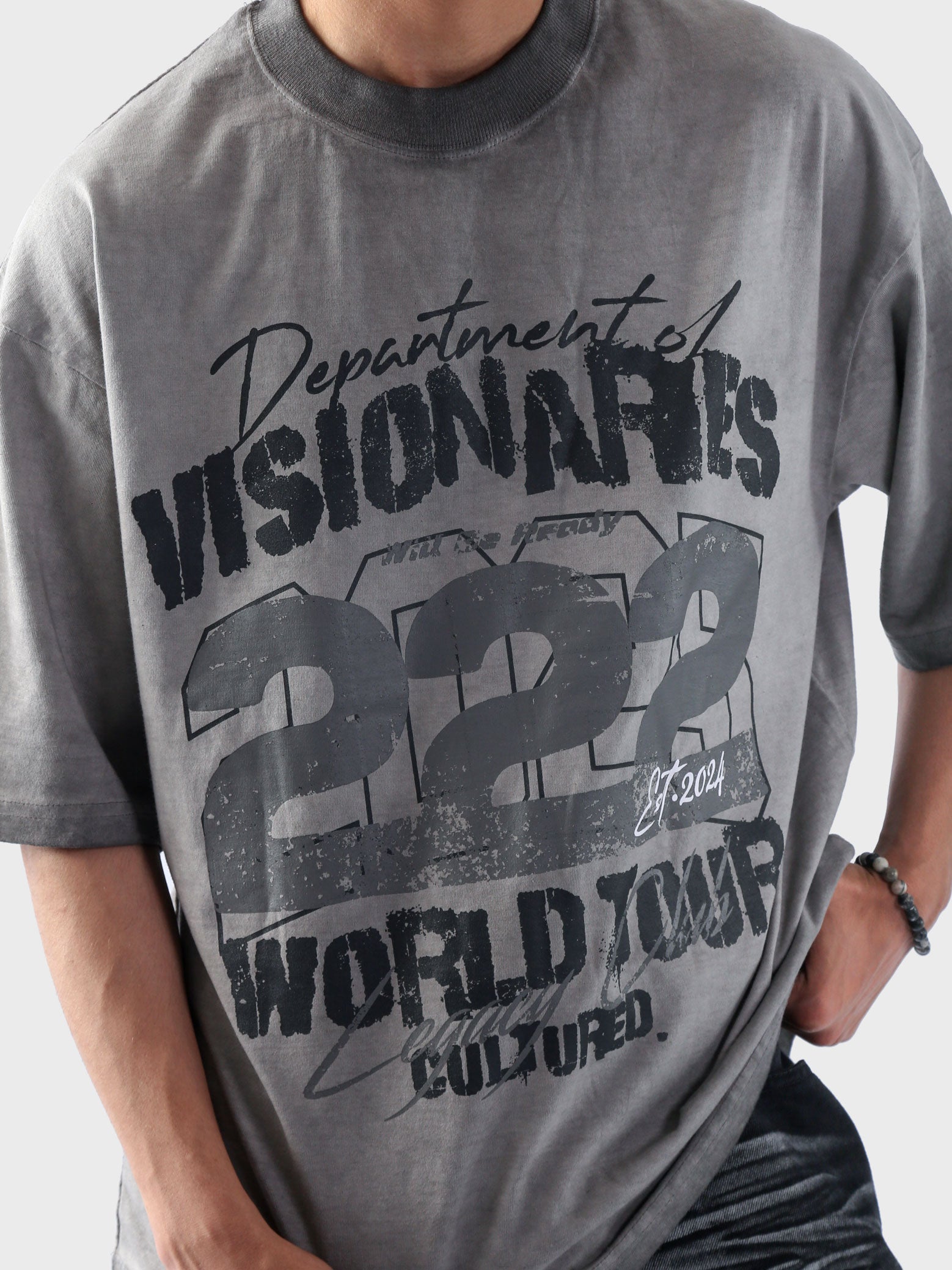Close-up of Cultured’s “Dept. of Visionaries” oversized t-shirt featuring bold 222 World Tour graphic on oil fade washed fabric.